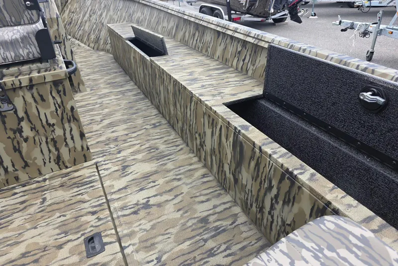 Slide: The Image of 2026 Smoker Craft Freedom 180 CC boat interior with camouflage design and storage compartments. - 10