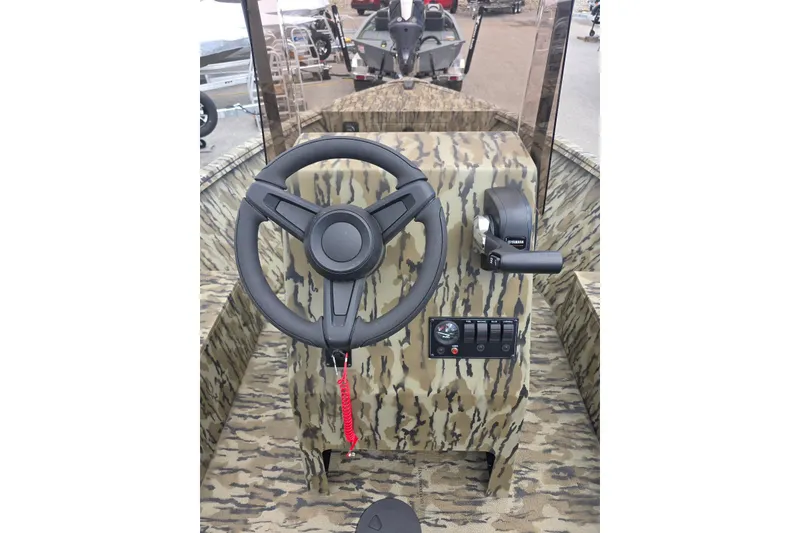 Slide: The Image of 2026 Smoker Craft Freedom 180 CC boat console with camouflage design and steering wheel. - 11