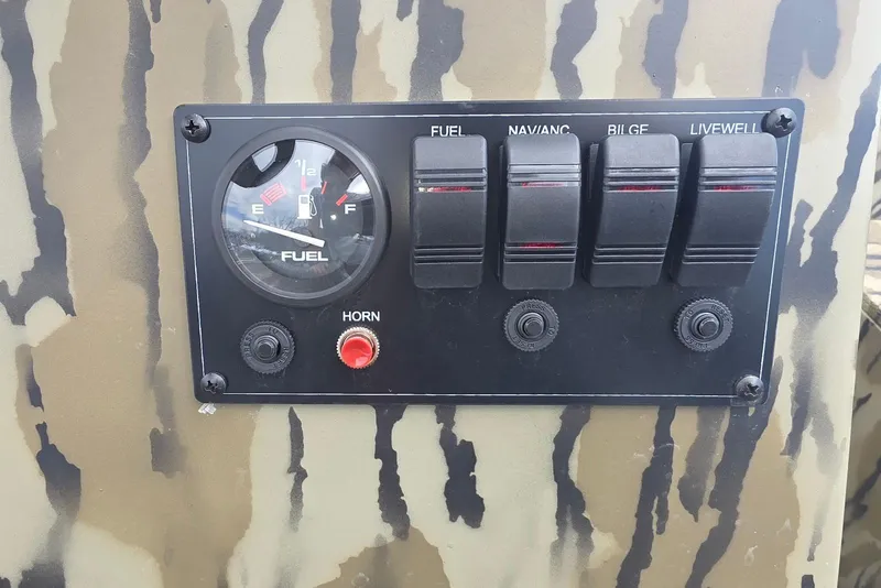 Slide: The Image of Control panel of 2026 Smoker Craft Freedom 180 CC boat with fuel gauge and switches. - 12