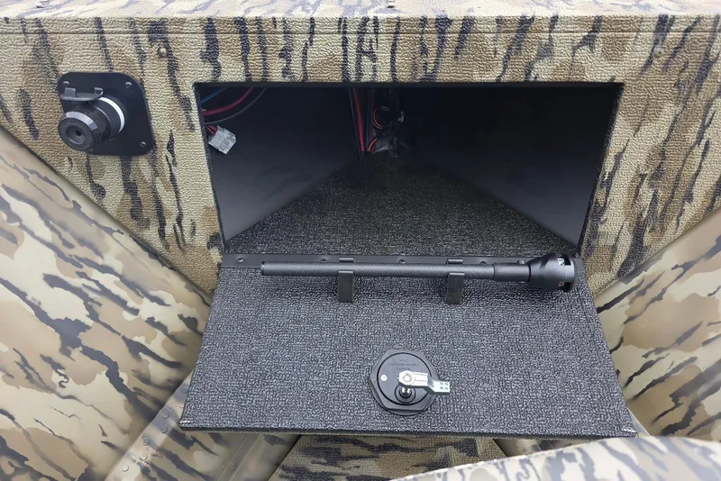 Slide: The Image of Storage compartment of 2026 Smoker Craft Freedom 180 CC boat with camouflage design. - 15