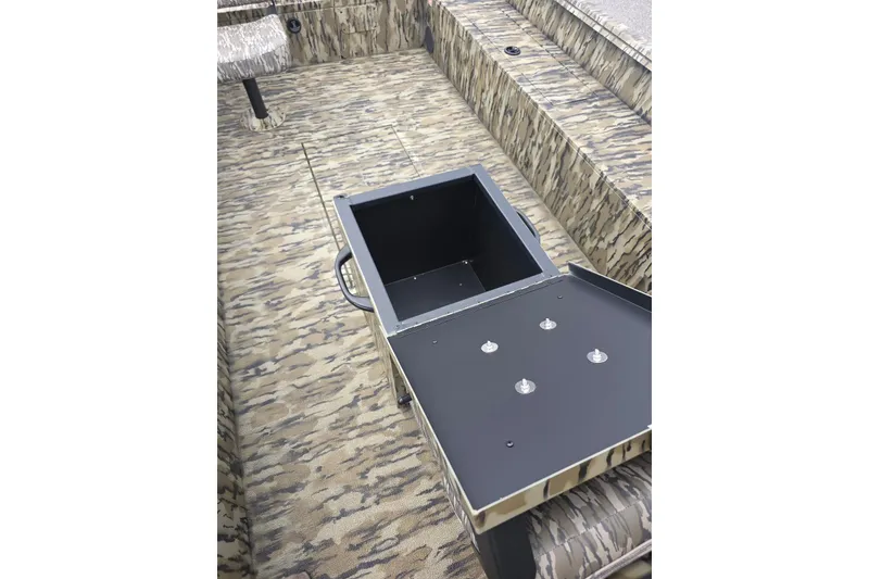 Slide: The Image of 2026 Smoker Craft Freedom 180 CC boat interior with open storage compartment. - 19