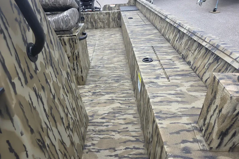 Slide: The Image of 2026 Smoker Craft Freedom 180 CC boat interior with camouflage design and seating. - 20