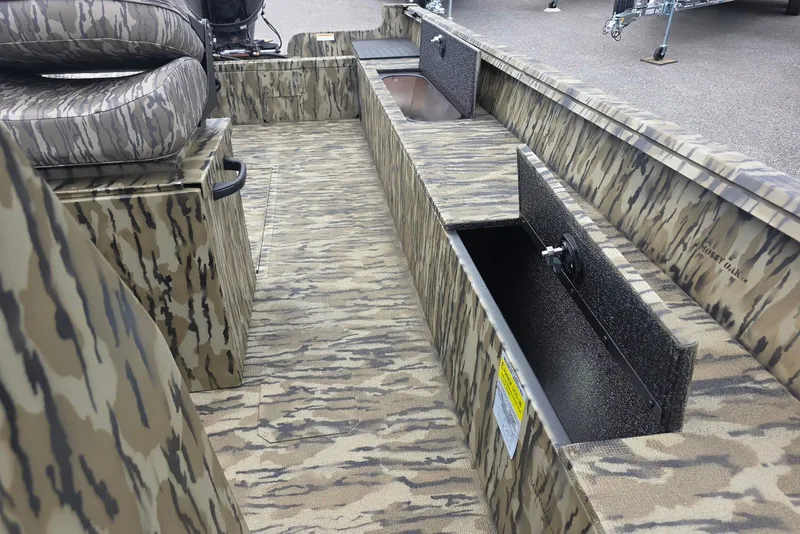 Slide: The Image of 2026 Smoker Craft Freedom 180 CC boat interior with camouflage design and storage compartments. - 21