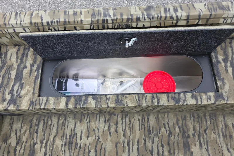 Slide: The Image of Camouflage storage compartment in 2026 Smoker Craft Freedom 180 CC boat. - 22