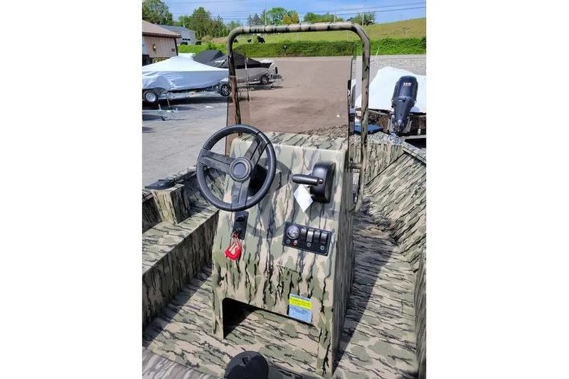 Slide: The Image of 2026 Smoker Craft Freedom 180 CC boat with camouflage interior and steering console. - 4
