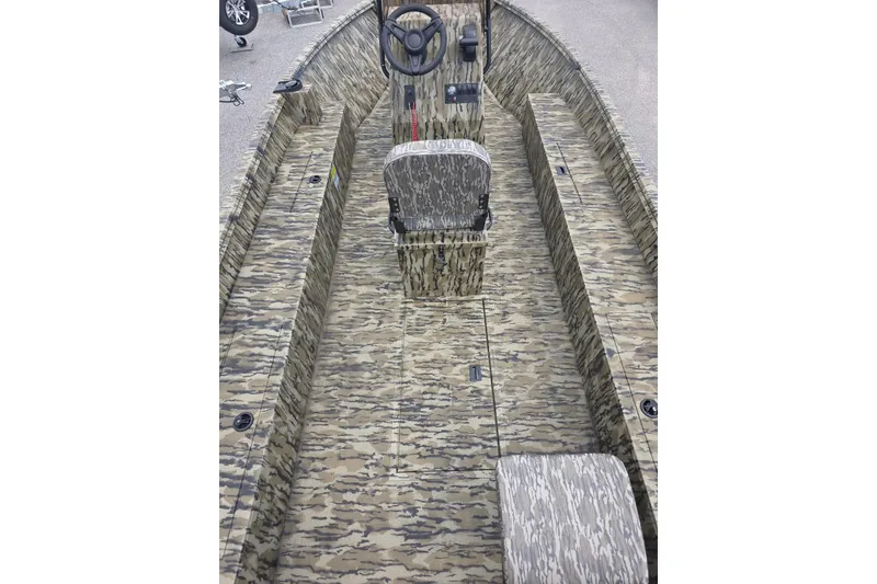 Slide: The Image of 2026 Smoker Craft Freedom 180 CC boat interior with camouflage design and central steering console. - 7