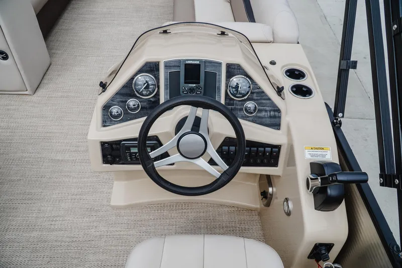 Slide: The Image of 2018 Godfrey SWEETWATER 2386 DT boat dashboard with steering wheel and controls. - 11