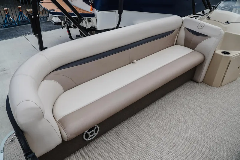 Slide: The Image of 2018 Godfrey SWEETWATER 2386 DT boat interior with beige seating and carpeted floor. - 14