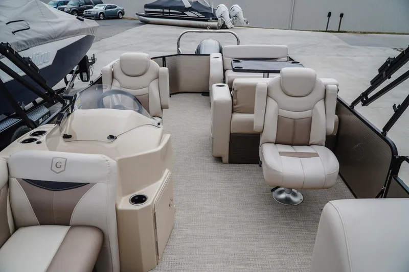 Slide: The Image of 2018 Godfrey SWEETWATER 2386 DT pontoon boat interior with beige seating and helm. - 16
