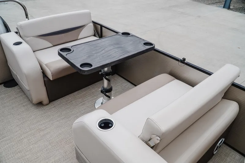 Slide: The Image of 2018 Godfrey SWEETWATER 2386 DT boat interior with seating and table setup. - 18