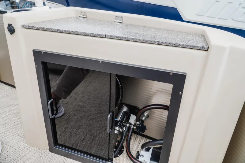 Slide: The Image of 2018 Godfrey SWEETWATER 2386 DT boat interior with storage compartment and plumbing. - 19