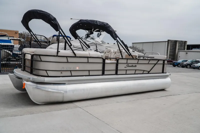 Slide: The Image of 2018 Godfrey SWEETWATER 2386 DT pontoon boat parked outdoors. - 2