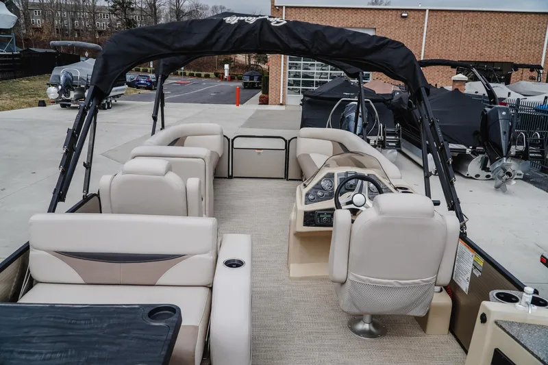 Slide: The Image of 2018 Godfrey SWEETWATER 2386 DT pontoon boat with beige seating and black canopy. - 5