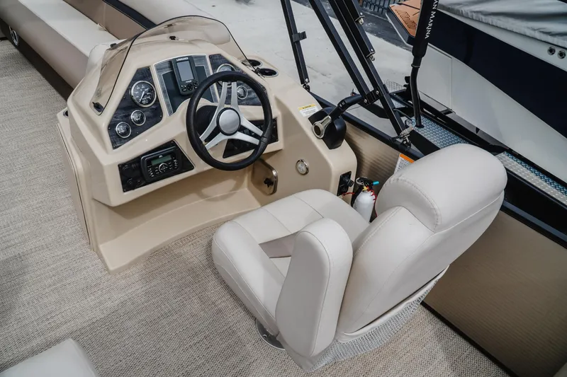Slide: The Image of 2018 Godfrey SWEETWATER 2386 DT boat interior with steering wheel and control panel. - 9