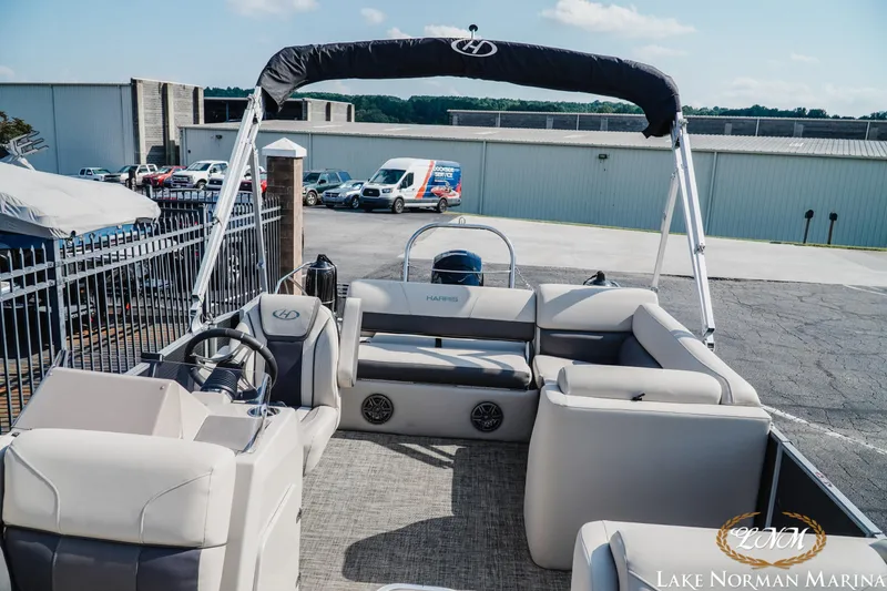 Slide: The Image of 2023 Harris Cruiser 210 pontoon boat at Lake Norman Marina, featuring spacious seating and modern design. - 10