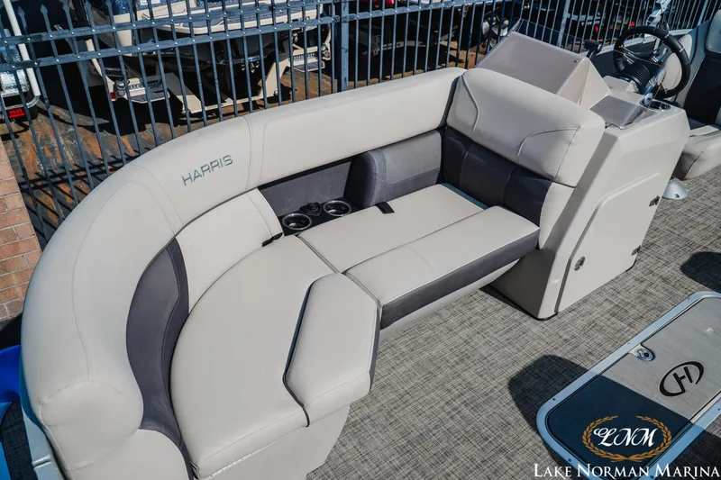 Slide: The Image of 2023 Harris Cruiser 210 boat interior with plush seating and cup holders at Lake Norman Marina. - 11
