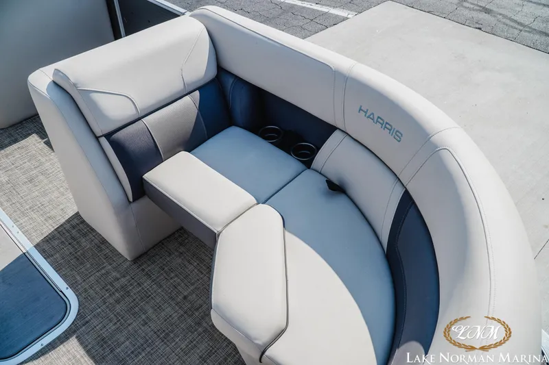 Slide: The Image of 2023 Harris Cruiser 210 boat interior with plush seating and cup holders. - 12