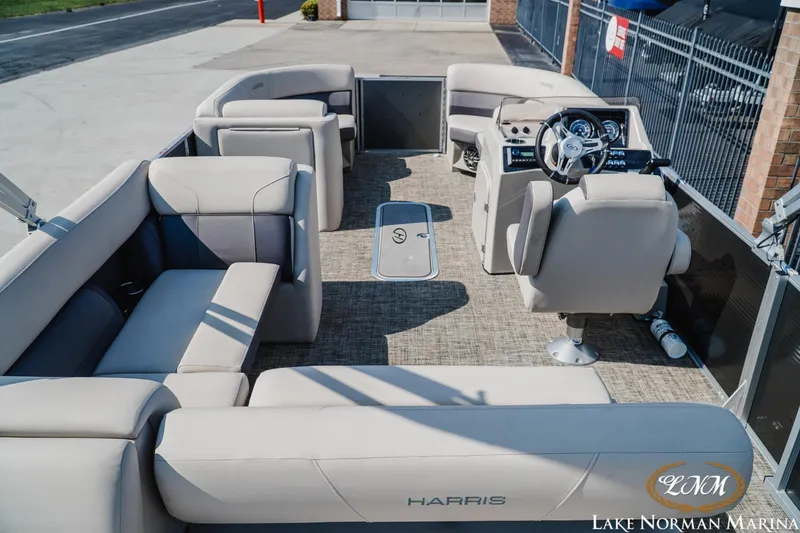Slide: The Image of 2023 Harris Cruiser 210 pontoon boat interior with plush seating and modern helm. - 5