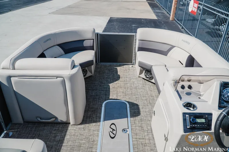 Slide: The Image of 2023 Harris Cruiser 210 pontoon boat interior with plush seating and modern dashboard. - 7