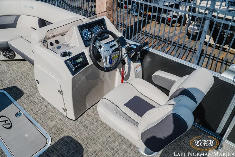 Slide: The Image of 2023 Harris Cruiser 210 boat interior with steering console and seating at Lake Norman Marina. - 8