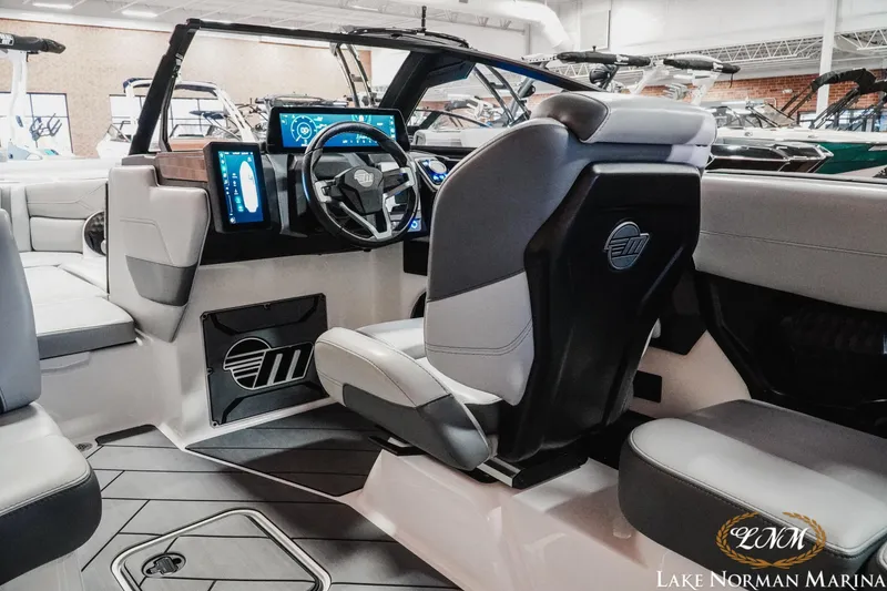 Slide: The Image of 2025 Malibu Wakesetter 23 LSV interior with modern dashboard and seating at Lake Norman Marina. - 11