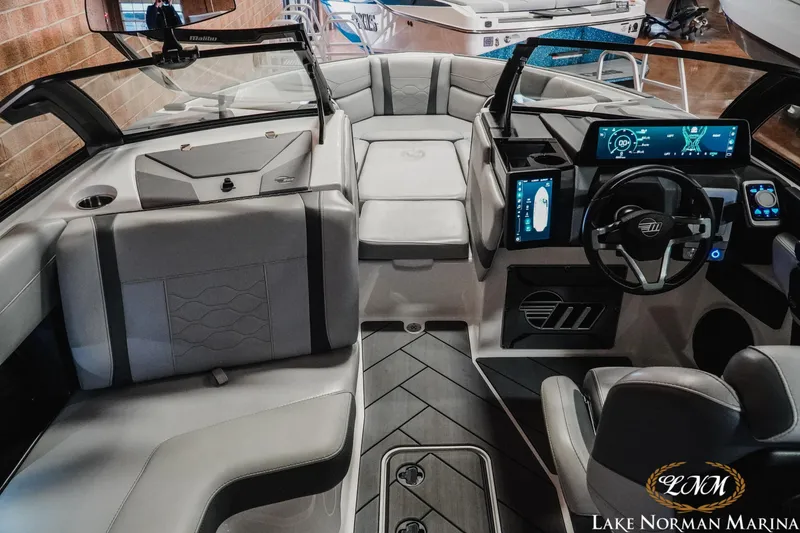Slide: The Image of 2025 Malibu Wakesetter 23 LSV interior with modern dashboard and seating at Lake Norman Marina. - 12