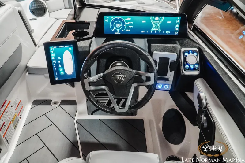 Slide: The Image of 2025 Malibu Wakesetter 23 LSV dashboard with advanced digital controls and steering wheel. - 13