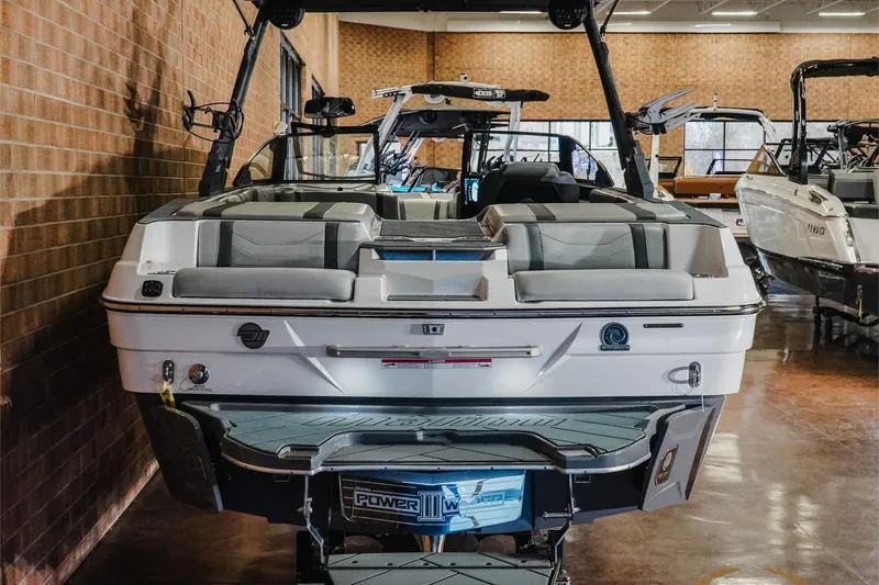 Slide: The Image of 2025 Malibu Wakesetter 23 LSV boat displayed indoors, showcasing sleek design and modern features. - 7