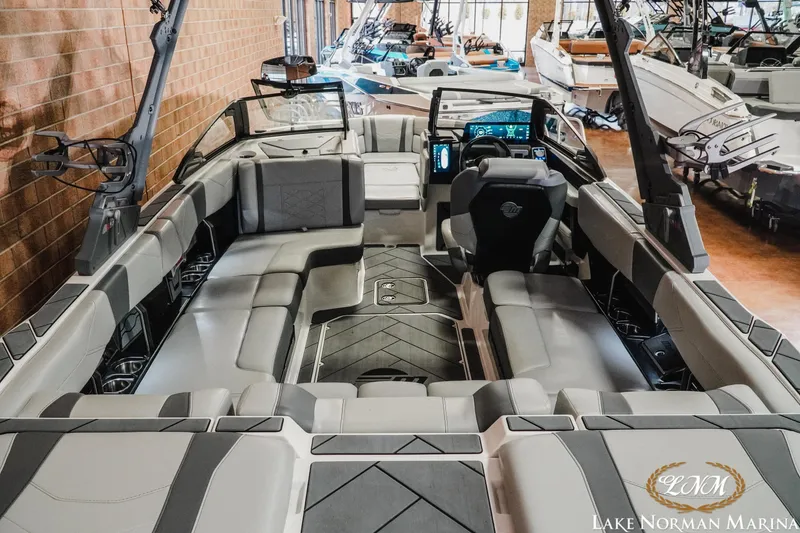 Slide: The Image of 2025 Malibu Wakesetter 23 LSV interior with sleek seating and modern dashboard at Lake Norman Marina. - 8