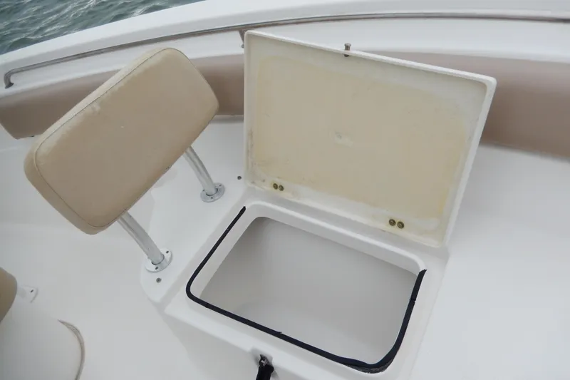 Slide: The Image of Open storage compartment on 2018 Sea Fox 226 Commander boat with beige seating. - 12