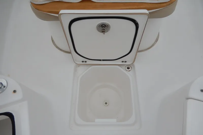 Slide: The Image of 2018 Sea Fox 226 Commander boat storage compartment with white hatch and seating area. - 16