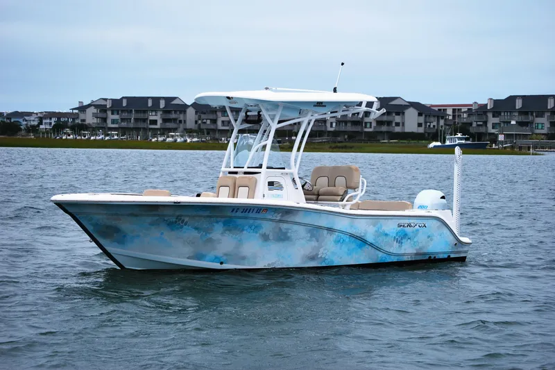 Slide: The Image of 2018 Sea Fox 226 Commander boat on water, with modern design and scenic backdrop. - 2
