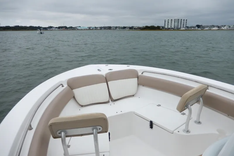 Slide: The Image of 2018 Sea Fox 226 Commander boat interior with cushioned seating, on calm waters. - 8