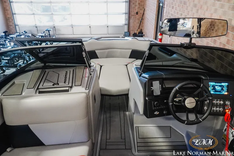 Slide: The Image of 2023 Moomba Max boat interior with modern dashboard and seating at Lake Norman Marina. - 10
