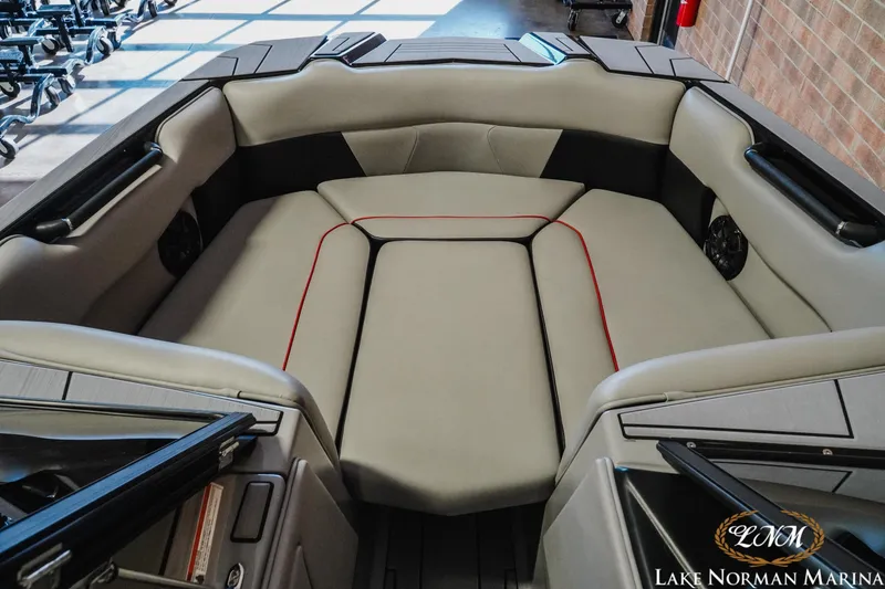Slide: The Image of 2023 Moomba Max boat interior with cushioned seating at Lake Norman Marina. - 14