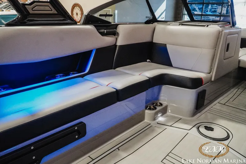 Slide: The Image of 2023 Moomba Max boat interior with blue LED lighting and comfortable seating. - 20