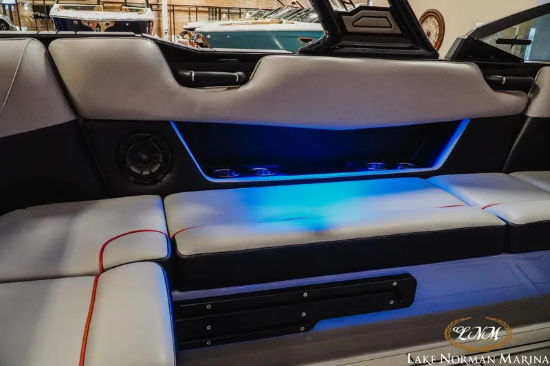 Slide: The Image of Interior of 2023 Moomba Max boat with blue LED lighting and cushioned seating. - 21
