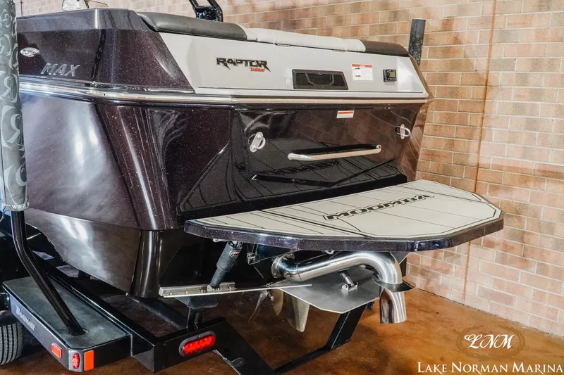 Slide: The Image of 2023 Moomba Max boat rear view with Raptor engine at Lake Norman Marina. - 4