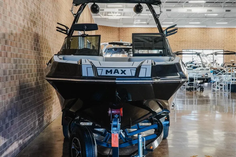 Slide: The Image of 2023 Moomba Max boat displayed indoors on a trailer. - 5