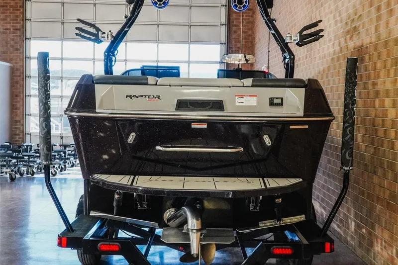 Slide: The Image of 2023 Moomba Max boat rear view in a garage setting. - 6