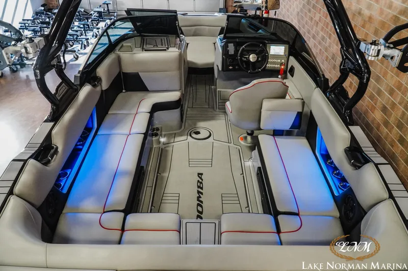 Slide: The Image of 2023 Moomba Max boat interior with modern seating and ambient blue lighting. - 8
