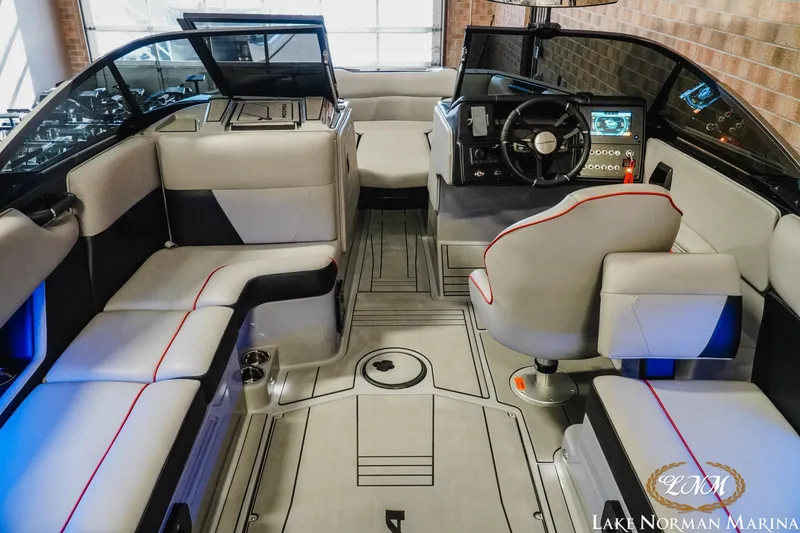 Slide: The Image of 2023 Moomba Max boat interior with modern seating and dashboard, Lake Norman Marina. - 9