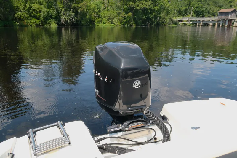 Slide: The Image of 2017 Tahoe 2150 boat with outboard motor on a calm river. - 11