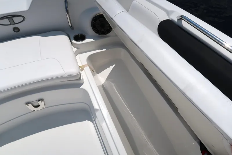 Slide: The Image of 2017 Tahoe 2150 boat interior with white seating and storage compartment. - 9