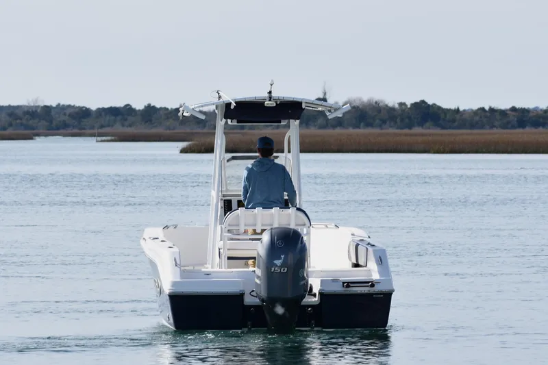 Slide: The Image of 2021 Robalo R180 Center Console boat cruising on calm waters. - 2