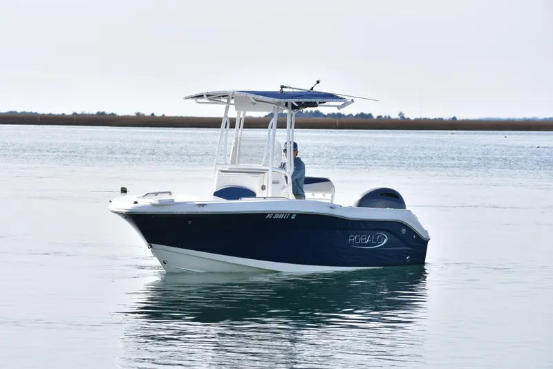Slide: The Image of 2021 Robalo R180 Center Console boat on calm water, featuring a sleek blue and white design. - 4