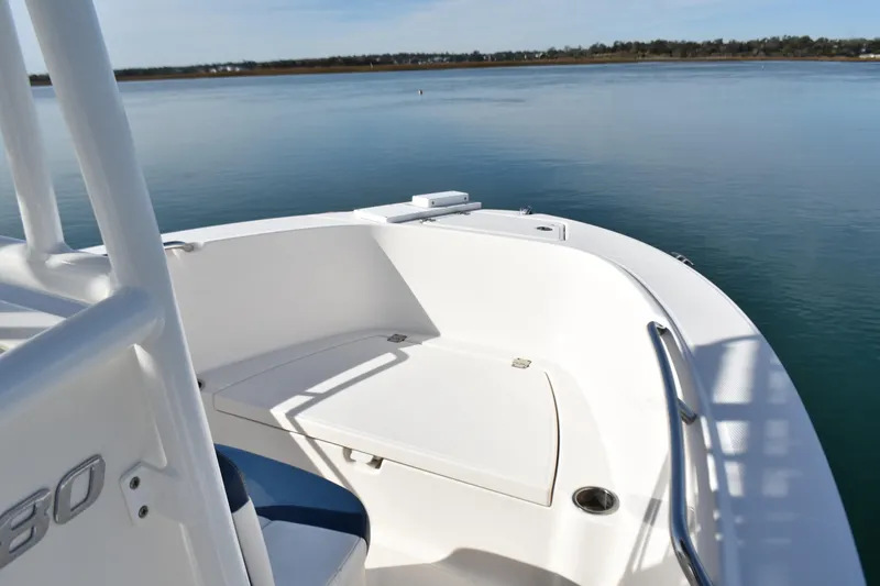 Slide: The Image of 2021 Robalo R180 Center Console boat on calm water, showcasing sleek design. - 5