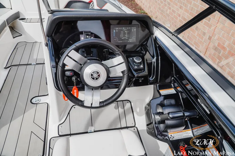 Slide: The Image of 2020 Yamaha Boats 212X steering console with modern controls and display at Lake Norman Marina. - 10