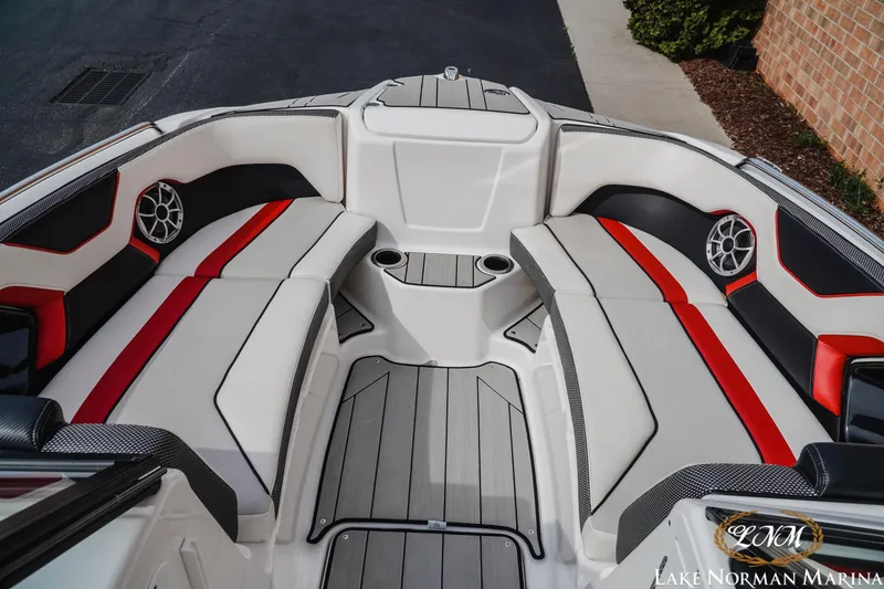 Slide: The Image of 2020 Yamaha Boats 212X interior with red and black accents, featuring spacious seating and cup holders. - 12