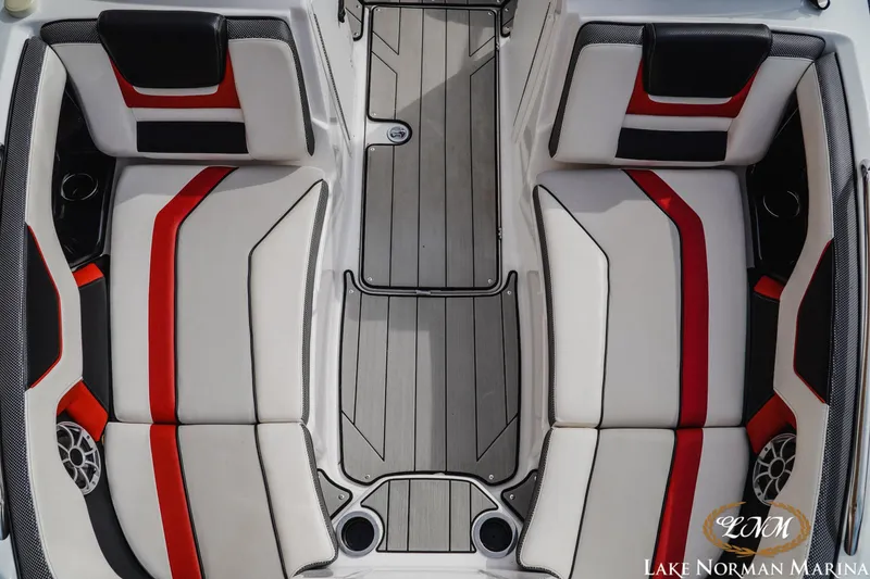 Slide: The Image of 2020 Yamaha Boats 212X interior with red and black accents, featuring spacious seating. - 14